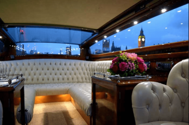 Luxury interior of the Thames Limo boat charter with Big Ben in the background.