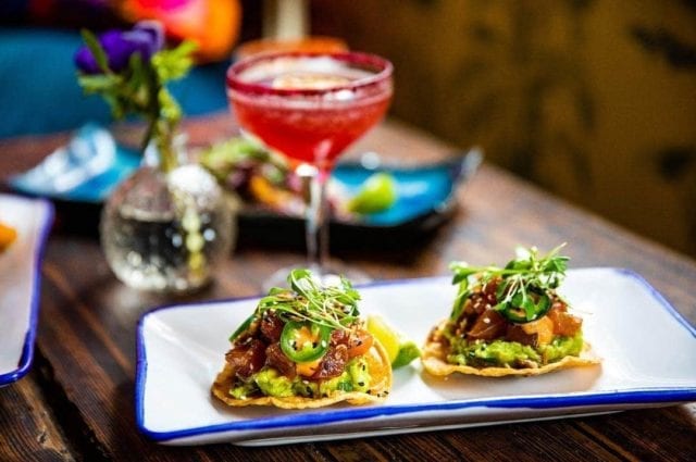 Santo Remedio, London. Mexican restaurant table featuring bottomless brunch tacos and a cocktail.