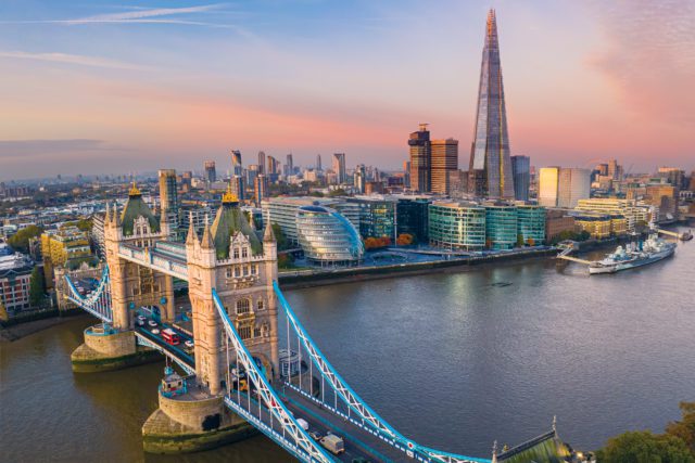 Aerial view of Tower Bridge In London, with The Shard and City Hall visible in the background.