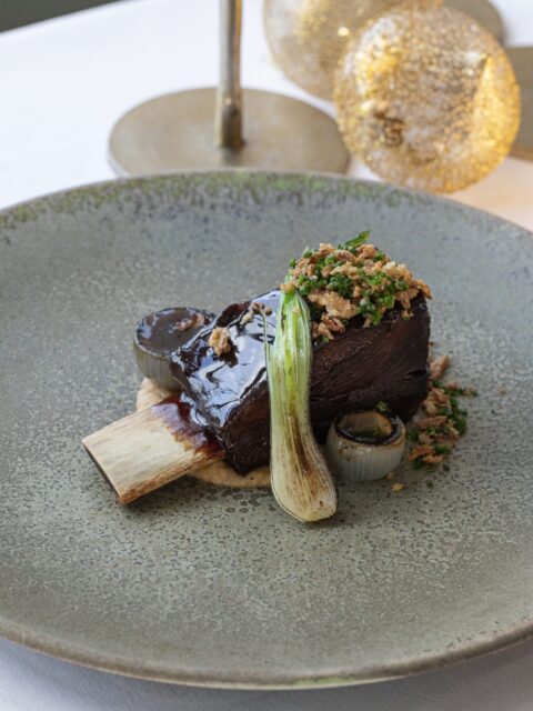 Miso glazed beef short rib with alliums and sprout tops. Image courtesy of Soho Communications.
