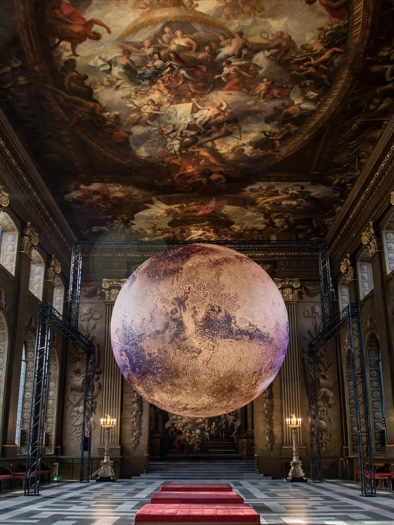 Mars by Luke Jerram is a large recreation of the planet Mars, created to scale using NASA data and imagery. It is pictured suspended inside the magnificent Baroque landmark the Painted Hall at the Old Royal Naval College in Greenwich, London.