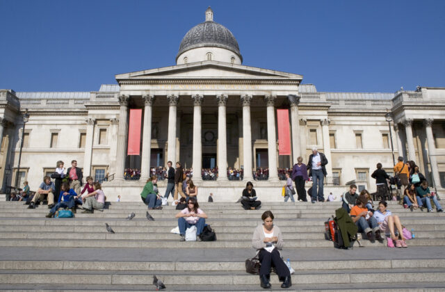 The National Gallery security measures have been increased following several attacks on iconic artworks. The exterior of the gallery is pictured with its famous columned front and people sitting on the steps that lead down to Trafalgar Square