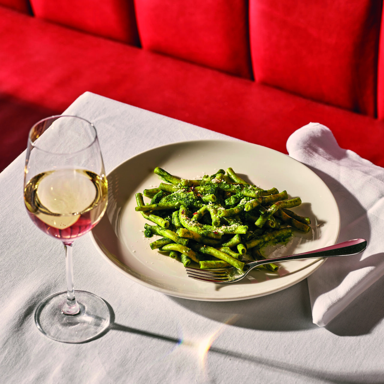 Plated food and glass of wine at Bistrot at Wild Honey restaurant