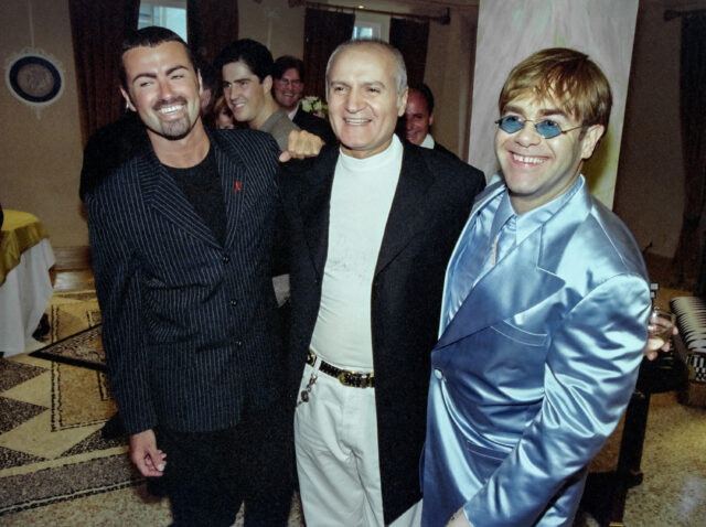 Gianni Versace Retrospective Exhibition. George Michael (L) stands with Gianni Versace and Elton John (R) at a party to launch Versace's book 'Men Without Ties'. Photograph Peter Macdiarmid.