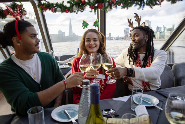 three people enjoying a London Thames Christmas Cruise by City Cruises