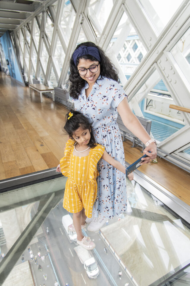 mum and daughter on glass floor at tower bridge