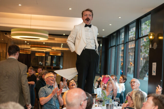 man on table at Faulty Towers Dining Experience